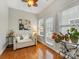 Cozy sunroom with natural light, neutral sofa, hardwood floor, and decorative plants at 4434 Patriots Hill Rd, Mint Hill, NC 28227
