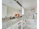 Bathroom featuring a large vanity with double sinks, a soaking tub with tile surround, and modern fixtures at 4731 Whispering Oaks Dr, Charlotte, NC 28213