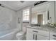 Bathroom features marble tiled shower, granite countertop vanity, toilet, and a window for natural light at 4731 Whispering Oaks Dr, Charlotte, NC 28213