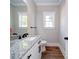 This bathroom features a granite countertop, black hardware, and a well-lit window and neutral paint at 4731 Whispering Oaks Dr, Charlotte, NC 28213