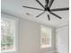 Bright bedroom with a ceiling fan, white trim, neutral walls and two large windows at 4731 Whispering Oaks Dr, Charlotte, NC 28213