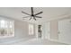 Bedroom with light gray walls, ceiling fan, white trim, and view of the backyard at 4731 Whispering Oaks Dr, Charlotte, NC 28213