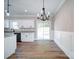 Bright dining area with chandelier lighting, white cabinets, granite countertops and sliding glass doors to the backyard at 4731 Whispering Oaks Dr, Charlotte, NC 28213