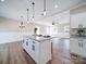Stylish kitchen island with granite countertops and a view of the open living space and modern lighting fixtures at 4731 Whispering Oaks Dr, Charlotte, NC 28213