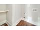 The laundry room features wood flooring and hookups for a washer and dryer and a storage shelf at 4731 Whispering Oaks Dr, Charlotte, NC 28213