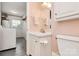 Functional bathroom featuring a sink, toilet, and a nearby laundry area with a washing machine at 501 Eastwood Dr, Gastonia, NC 28054