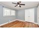 Bright bedroom with wood floors, a ceiling fan, double windows, and a closet for ample storage at 501 Eastwood Dr, Gastonia, NC 28054