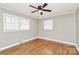 Bright bedroom with hardwood floors, a ceiling fan, and two windows at 501 Eastwood Dr, Gastonia, NC 28054