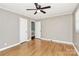 Well-lit bedroom with hardwood floors, a ceiling fan, and two closets at 501 Eastwood Dr, Gastonia, NC 28054