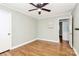 A comfortable bedroom with light green walls, hardwood floors, and a ceiling fan at 501 Eastwood Dr, Gastonia, NC 28054