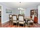 Formal dining room featuring hardwood floors, large windows, and elegant furnishings at 501 Eastwood Dr, Gastonia, NC 28054