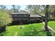 Beautiful two-story home with green lawn and mature trees on a sunny day at 501 Eastwood Dr, Gastonia, NC 28054