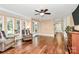 Inviting living room with hardwood floors, comfortable armchairs, many windows, and neutral wall color at 501 Eastwood Dr, Gastonia, NC 28054