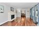 Spacious living room with hardwood floors, fireplace, and view into the dining room at 501 Eastwood Dr, Gastonia, NC 28054