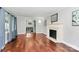 Open living room with fireplace, hardwood floors, and view into the foyer at 501 Eastwood Dr, Gastonia, NC 28054