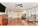 Cozy living room with hardwood floors, ceiling fan, comfortable seating, and many windows at 501 Eastwood Dr, Gastonia, NC 28054