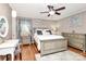 Cozy main bedroom with a ceiling fan, wood floors, and stylish furniture at 501 Eastwood Dr, Gastonia, NC 28054