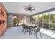 Comfortable enclosed patio with a table and chairs, brick wall, and outdoor view from screened windows at 501 Eastwood Dr, Gastonia, NC 28054