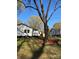 Spacious backyard featuring a well-maintained lawn, established trees, and a charming rear deck for outdoor enjoyment at 609 Mccarten St, Monroe, NC 28112