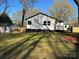 Spacious backyard featuring a lush green lawn and views of a charming home exterior at 609 Mccarten St, Monroe, NC 28112