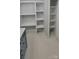 Bright bathroom featuring gray cabinets, white countertops, and large wall shelving at 609 Mccarten St, Monroe, NC 28112