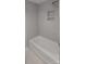 Neutral toned bathroom with sleek tub and shower with built in shelf at 609 Mccarten St, Monroe, NC 28112