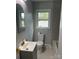 Bathroom featuring sleek gray tiling, modern fixtures, and a well-lit vanity area at 609 Mccarten St, Monroe, NC 28112