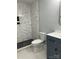 Modern bathroom featuring a stylish tiled shower with glass enclosure, sleek fixtures, and a contemporary vanity at 609 Mccarten St, Monroe, NC 28112
