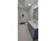 Modern bathroom featuring double shower, gray cabinets, gold fixtures, and white countertops at 609 Mccarten St, Monroe, NC 28112