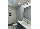 Modern bathroom featuring a glass shower with marble-style tile, black fixtures, and stylish vanity at 609 Mccarten St, Monroe, NC 28112