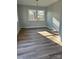 Spacious bedroom with sunlight shining on hardwood style floors at 609 Mccarten St, Monroe, NC 28112