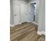 Hallway with hardwood style floors leads to a bathroom at 609 Mccarten St, Monroe, NC 28112
