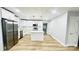 Beautiful kitchen featuring white cabinets, an island, stainless steel appliances, and wood floors at 609 Mccarten St, Monroe, NC 28112