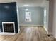 Bright living room with hardwood floors, modern fireplace, and ample natural light from large windows at 609 Mccarten St, Monroe, NC 28112