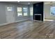 Bright living room with modern fireplace, ample windows, and hardwood floors at 609 Mccarten St, Monroe, NC 28112