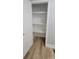 Well-lit pantry with white shelving and wood grain flooring, enhancing storage and organization at 609 Mccarten St, Monroe, NC 28112