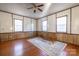 Living room area with wood floors, large rug, and windows that bring in natural light at 6441 Highway 73 W Hwy, Mount Gilead, NC 27306