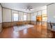 Bright, open living room with wood floors, decorative rug, and wood-paneled walls at 6441 Highway 73 W Hwy, Mount Gilead, NC 27306
