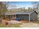 Backyard view of the home with a covered porch and exterior storage unit at 6501 Thamesmead Ln, Mint Hill, NC 28227