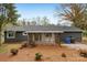 View of the backyard with a screened-in porch and neat landscaping at 6501 Thamesmead Ln, Mint Hill, NC 28227