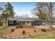 Backyard view with a screened-in porch, utility shed, and tidy landscaping at 6501 Thamesmead Ln, Mint Hill, NC 28227