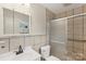 Bathroom features tile shower with glass doors and neutral tile at 6501 Thamesmead Ln, Mint Hill, NC 28227