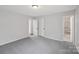 Bedroom features neutral carpet and a view into bathroom at 6501 Thamesmead Ln, Mint Hill, NC 28227