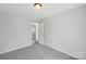 Bedroom with neutral carpet and natural light. View into hallway at 6501 Thamesmead Ln, Mint Hill, NC 28227
