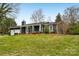 Inviting single-story house with a lush green lawn and covered front porch at 6501 Thamesmead Ln, Mint Hill, NC 28227