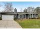 Charming single-story home featuring a well-manicured front yard and attached garage at 6501 Thamesmead Ln, Mint Hill, NC 28227