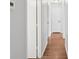 Hallway with hardwood floors and white walls, leading to various rooms at 6501 Thamesmead Ln, Mint Hill, NC 28227
