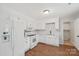 Clean kitchen featuring white cabinets, appliances, and hardwood floors at 6501 Thamesmead Ln, Mint Hill, NC 28227