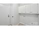 Bright laundry room features white cabinets and neutral paint at 6501 Thamesmead Ln, Mint Hill, NC 28227