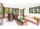 Inviting sunroom with tile floor, wicker furniture, and lots of natural light at 6501 Thamesmead Ln, Mint Hill, NC 28227